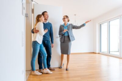 Real Estate Agent showing house to a young couple