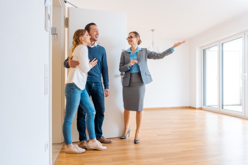 Real Estate Agent showing house to a young couple